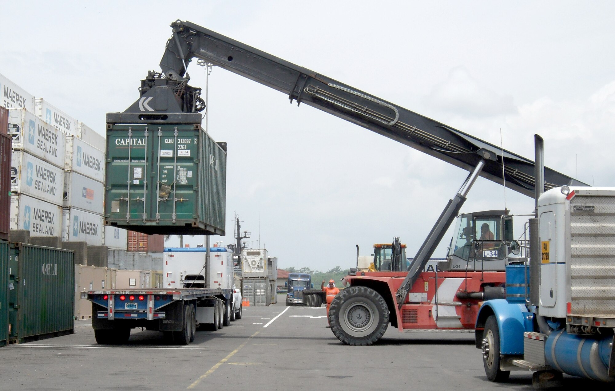 Airmen load cargo containers onto a flatbed truck at the Panama City port in support of New Horizons Panama 2010, a 12-week humanitarian assistance mission. More than 250 Airmen, Soldiers and Marines will deploy to six construction sites and five medical missions in Panama. (U.S. Air Force photo/Staff Sgt. Teresa Burger)