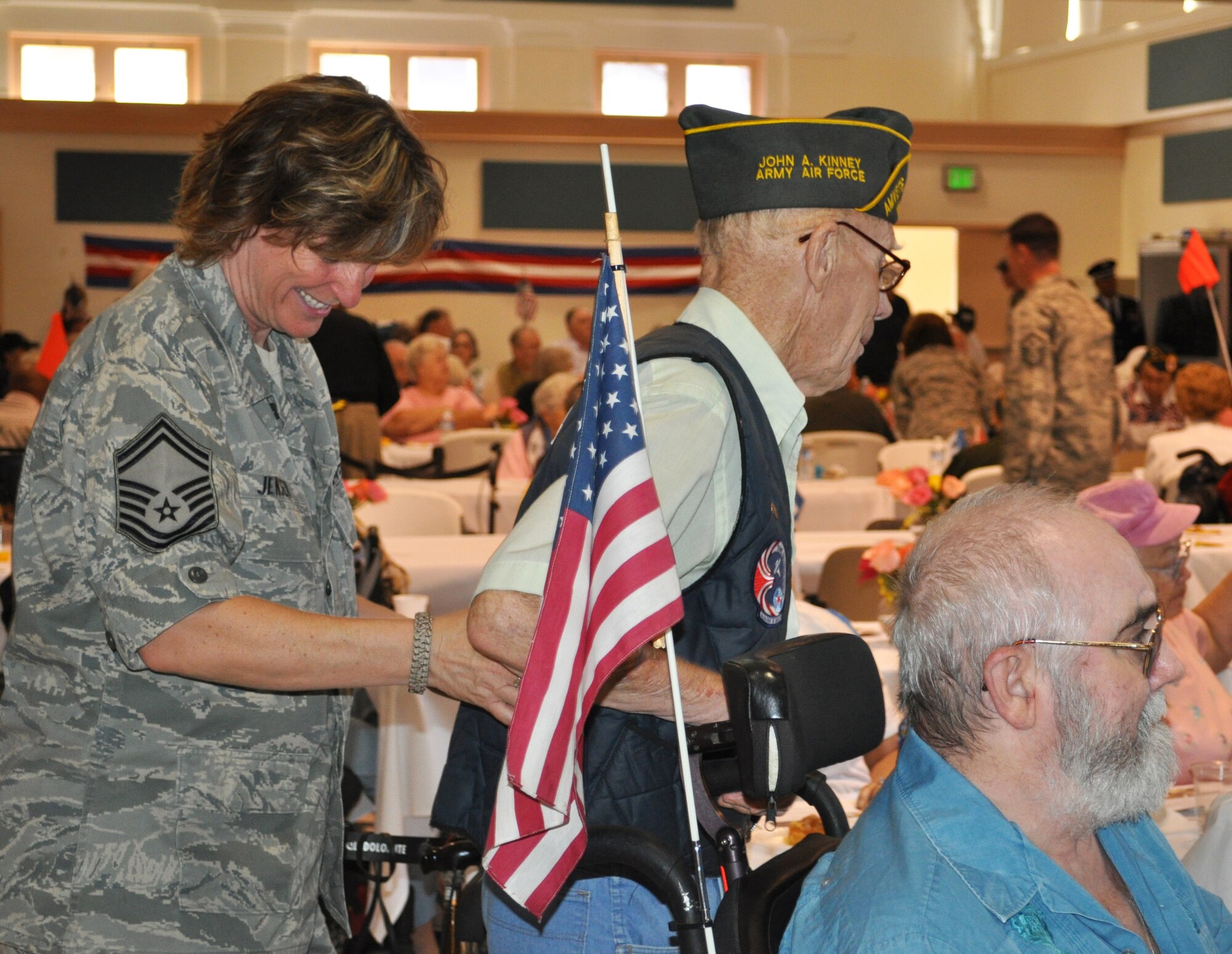 TRAVIS AIR FORCE BASE, Calif. -- Senior Master Sgt. Sherry Jensen helps a veteran to his seat during "Operation Gratitude" at the California Veterans Home, Yountville. (U.S. Air Force photo/Senior Master Sgt. Ellen L. Hatfield)