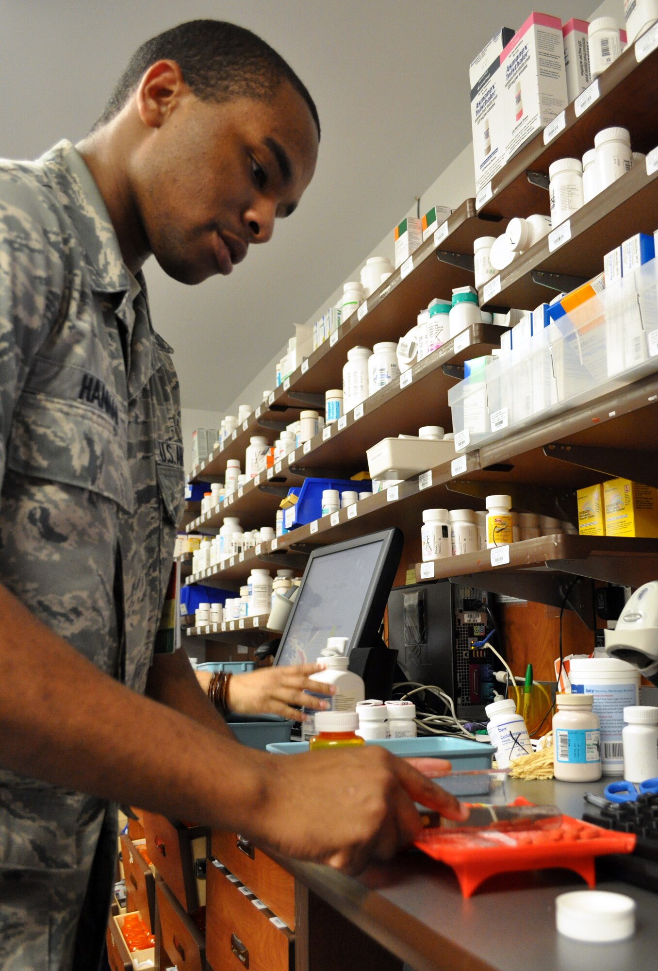 Senior Airman Terrell Hannah counts pills while dispensing medication at the 14th MDG Pharmacy June 15. Airman Hannah is a pharmacy technician with the 14th MDSS. (U.S. Air Force photo/Airman 1st Class Chase Hedrick). 