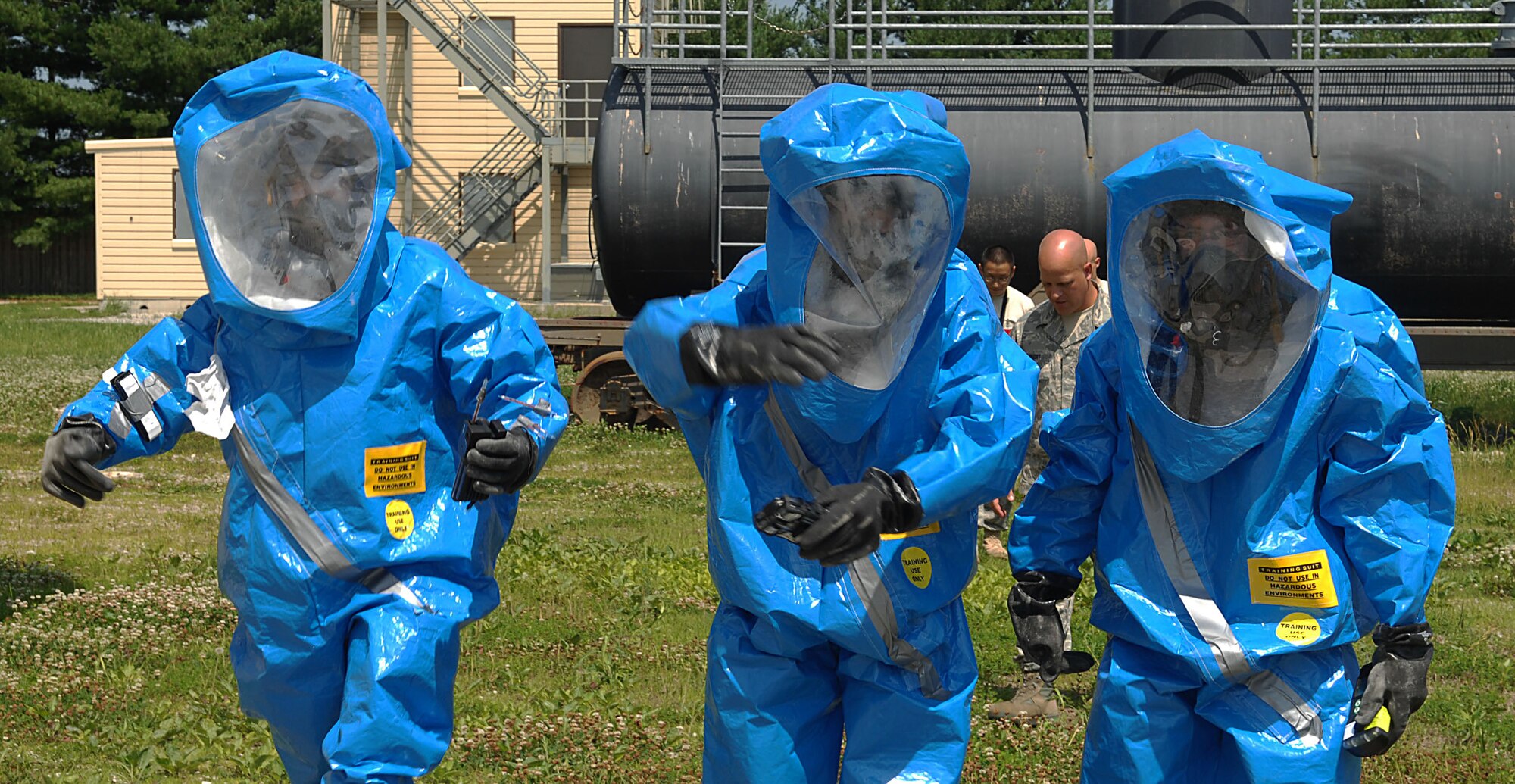 SCOTT AIR FORCE BASE, Ill. -- Left, Airman 1st Class Daniel Salas Dominguez, Senior Airman Tyler Haugland and Airman 1st Class Tim Burnett, all 375th Aerospace Medicine Squadron Bioenvironmental Flight technicians, walk away from a simulated chlorine and ethanol spill to evaluate their findings after taking samples during an in-house exercise June 10. The exercise was put on by the flight to give technicians keep technicians familiar with their equipment and procedures. (U.S. Air Force photo by Hannah Hill)