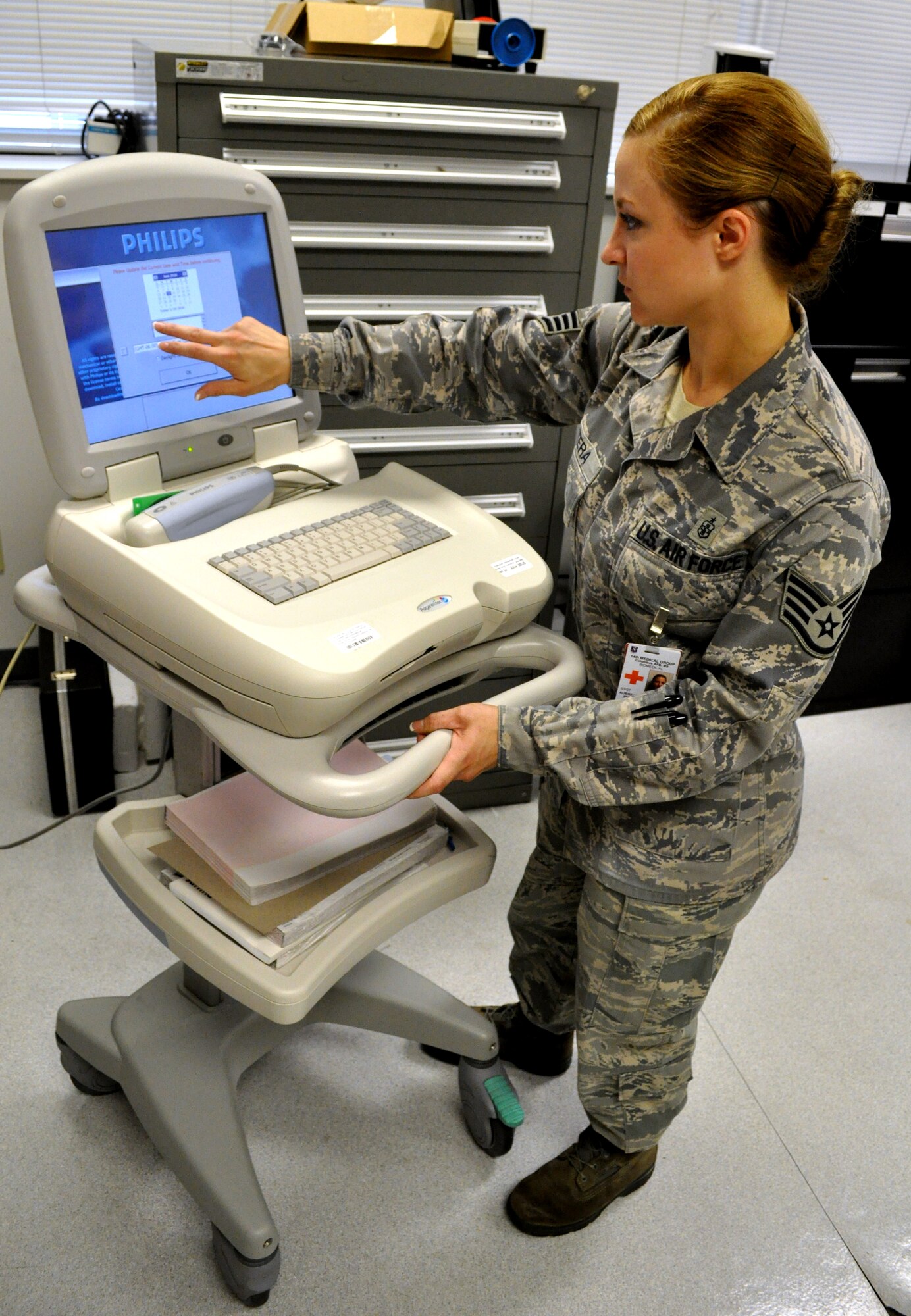 Staff Sgt. Aubrey Mitera prepares an EKG testing machine to be reloaded with software June 15 at the Koritz Clinic. Sergeant Mitera is the NCOIC of medical equipment repair with the 14th MDSS. (U.S. Air Force photo/Senior Airman Jacob Corbin).
