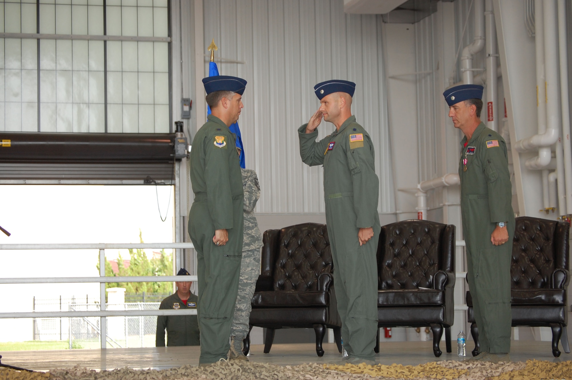Lt. Col. Phil Heseltine (center) delivers a salute to Colonel James Morgan, 6th Air Mobility Wing, after receiving the flag of command for the 911th Air Refueling Squadron on June 18, 2010. (USAF photo by SSgt. Terrica Jones, 916ARW/PA).