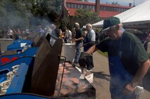 MINOT, N.D. -- Bill Dennis, member of the Military Affairs Committee and 741st Missile Squadron honorary commander, prepares food on the grill for Military Appreciation Day at Roosevelt Park Zoo here June 16. Sponsored by the Minot Chamber of Commerce and the Military Affairs Committee, military members and their families were able to visit the zoo free of charge as a form of “thanks” for their service. (U.S. Air Force photo by Senior Airman Michael J. Veloz)