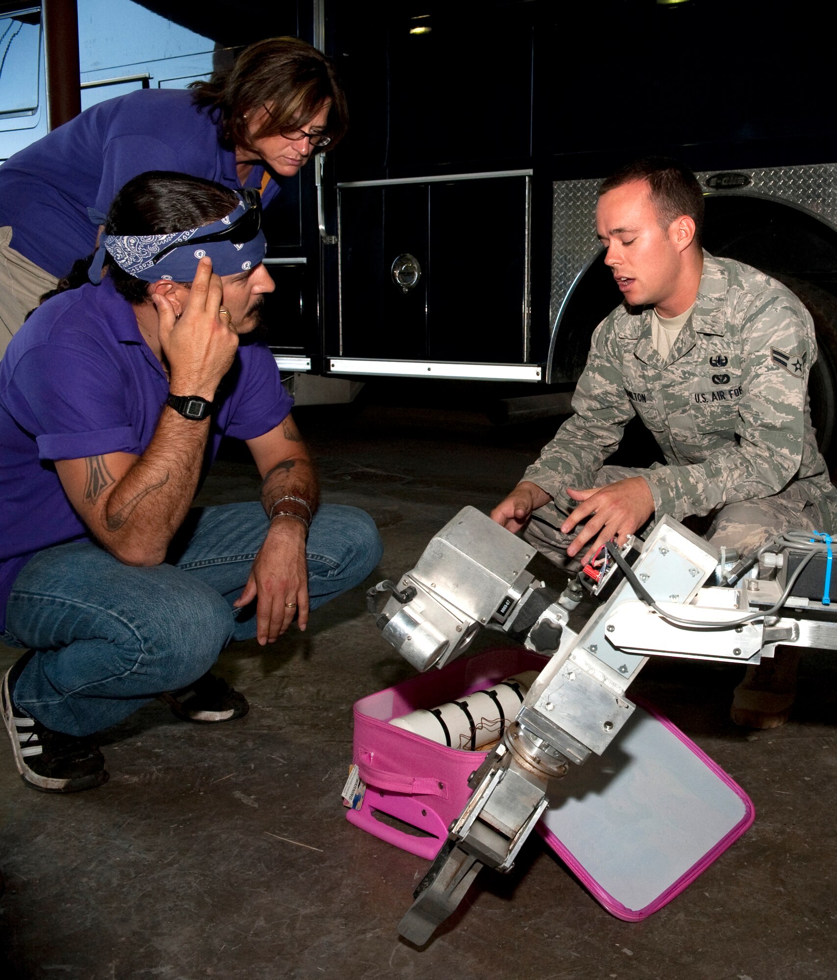 HOLLOMAN AIR FORCE BASE, N.M. -- Alex Vargas and Kimberly Warf, members of the 2010 class of Leadership Otero, check out a robot used by the Explosive Ordinance Disposal flight while Airman 1st Class Brook Hamilton, 49th Civil Engineer Squadron, explains its capabilities, June 9, 2010. The members of Leadership Otero received tours of Fire Station 1, the EOD flight and the Holloman High Speed Test Track during a base tour. (U.S. Air Force photo by Airman 1st Class Sondra Escutia / Released)