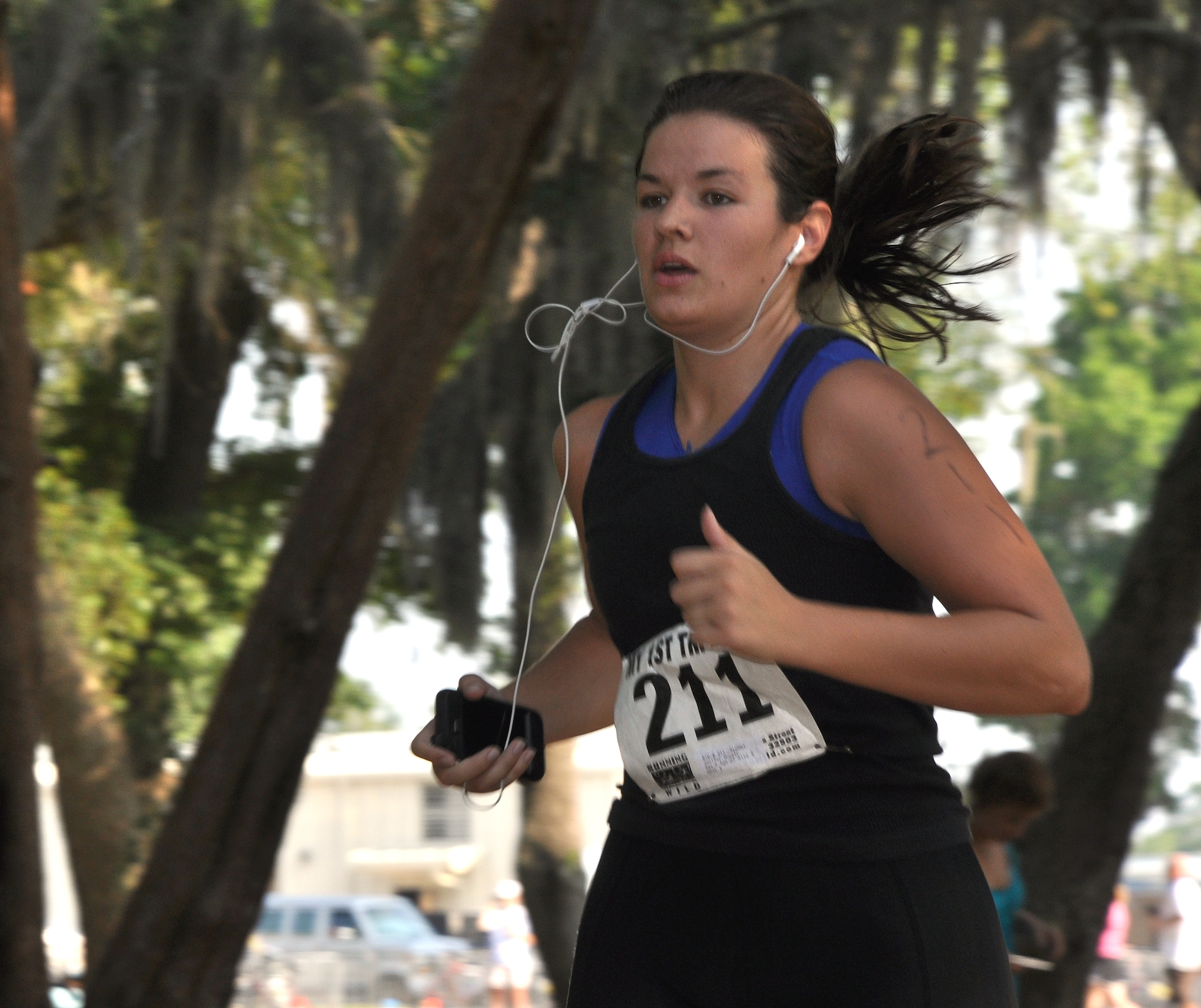 EGLIN AIR FORCE BASE, Fla. -- Jenifer Mouser runs the final phase of Eglin's 11th annual My First Tri June 19. There were 337 athletes in the event and 181 of them participated for the first time. Each individual completed a 200-meter swim, an 8-mile bike ride and a 2.5 mile run. Everyone received a medal and all results are listed on www.eventtiming.com. (Air Force photo/Chrissy Cuttita)
