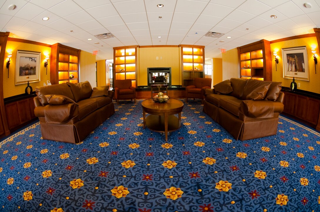 The inviting atmosphere of the Presidential Inn is complete with leather couches, a fireplace and a cafe adjacent to the lobby, The new lodging facility opened its doors to servicemembers and their families here June 11. (U.S. Air Force photo/Staff Sgt. Sophia Piellusch)