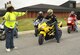 JOINT BASE ANDREWS, Md. -- Vanessa Jones, left, Cape Fox Professional Services motorcycle safety instructor, guides a group of sports bike riders through various training scenarios during a Military Sport Bike Rider Course held on Andrews June 16. The purpose of the specialized course is to illustrate the correct technique when cornering and handling sport bikes. Classes are held on Andrews at least once a month, and throughout the National Capital Region weekly. (U.S. Air Force photo by Bobby Jones)