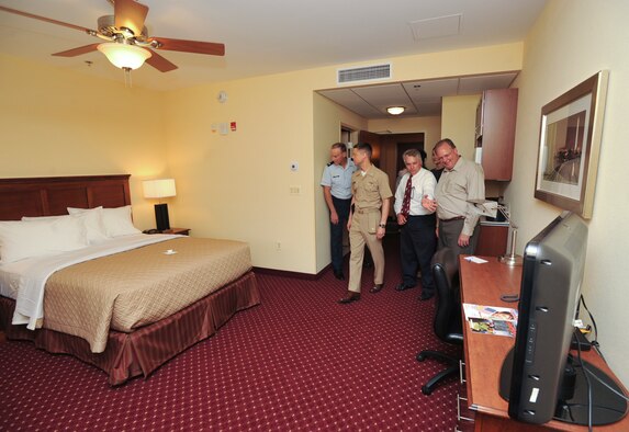 JOINT BASE ANDREWS, Md. -- Joint Base Andrews members and honored guests file into a spacious model room of The Presidential Inn here after the grand opening ceremony June 14. The $46.6 million, 265-room facility boasts a coffee shop, an indoor and outdoor lounge area, and soon will offer a sundry store. (U.S. Air Force photo by Bobby Jones)