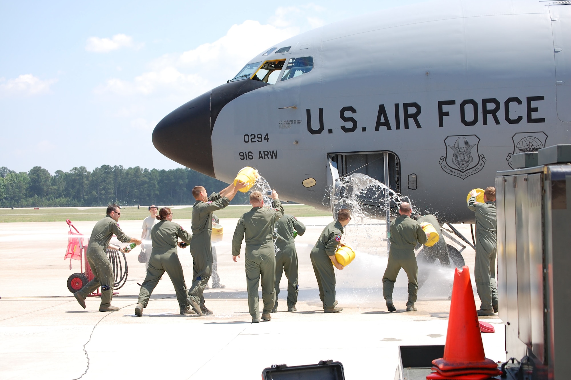 Pilots and crew members from the 916th Air Refueling Wing throw water on Lt. Col. William Uptmor, 911th Air Refueling Squadron commander, as he completes his final tanker flight with the wing. Col. Uptmor was the first commander for the squadron as it became the first tanker active associate in Air Force history. (USAF photo by Capt. Eric Babson, 911ARS)