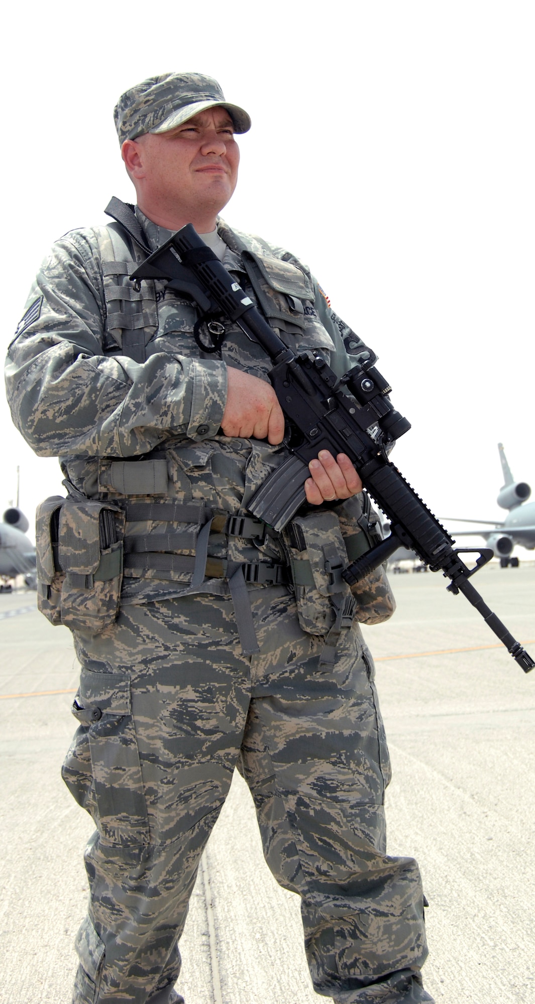 Staff Sgt. Frederick Bushby, security forces craftsman with the 380th Expeditionary Security Forces Squadron, watches the flightline in the 380th Air Expeditionary Wing operations area at a nondisclosed base in Southwest Asia on June 21, 2010. Sergeant Bushby is deployed from the 42nd Security Forces Squadron at Maxwell Air Force Base, Ala., and his hometown is Waterloo Iowa. (U.S. Air Force Photo/Staff Sgt. Jeremy Larlee/released)