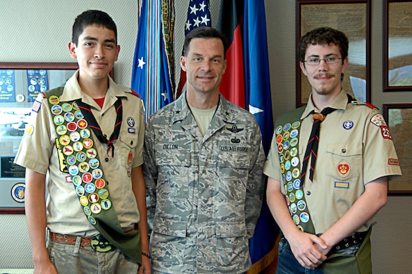 Eagle Scouts David Ladnier (right) and Quinton Leith take a photo with Brig. Gen. Dillon during a coining ceremony on June 5, 2010. Both Ladnier and Leith organized and managed a cleanup project in Donnelly Park on Ramstein Air Base, Germany. Ramstein’s Boy Scout Troop 232 has had three Scouts gain the rank of Eagle in just over a month. (U.S. Air Force Airman 1st Class Ciara M. Travis)