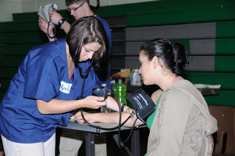 Airman 1st Class April Loeper, a medical technician with the 193rd Special Operations Wing's Medical Group takes the blood pressure of Michelle Costa during a sports physical. Loeper and other members of the 193rd Medical Group provided free sports physical at Pahoa High School in Pahoa, Hawaii, on June 15th, 2010. Members of the 193rd Medical Group out of Middletown, Pa., are in Hilo, Hawaii, for Medical Innovative Readiness Training.