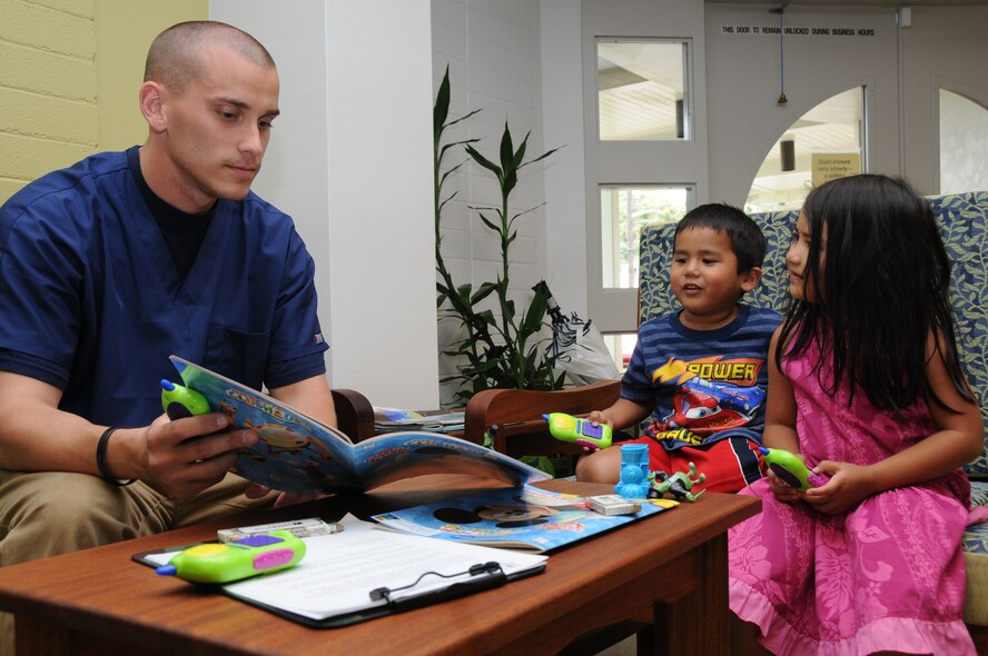 Staff Sgt. Matthew Winkelspecht, a medical logistics technician with the 193rd Special Operations Wing's Medical Group  entertains Elijah and Elise Auna, while their Father Aaron Auna gets a free health screening. Winkelspecht, and other members of the 193rd Medical Group provided free health screenings atthe Hawaii County Office of Aging in Hilo, Hawaii, on June 14th, 2010. Members of the 193rd Medical Group out of Middletown, Pa., are in Hilo for Medical Innovative Readiness Training.