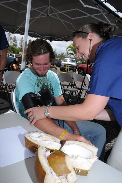 Staff Sgt. Katie Duff, a medical technician with the 193rd Special Operations Wing's Medical Group out of Middletown, Pa., takes the blood pressure of a patient. Duff and other members of the 193rd Medical Group provided free health screenings at Maku'u Farmer's Market in Pahoa, Hawaii, on June 13th, 2010. Members of the 193rd Medical Group are in Hilo, Hawaii, for Medical Innovative Readiness Training.