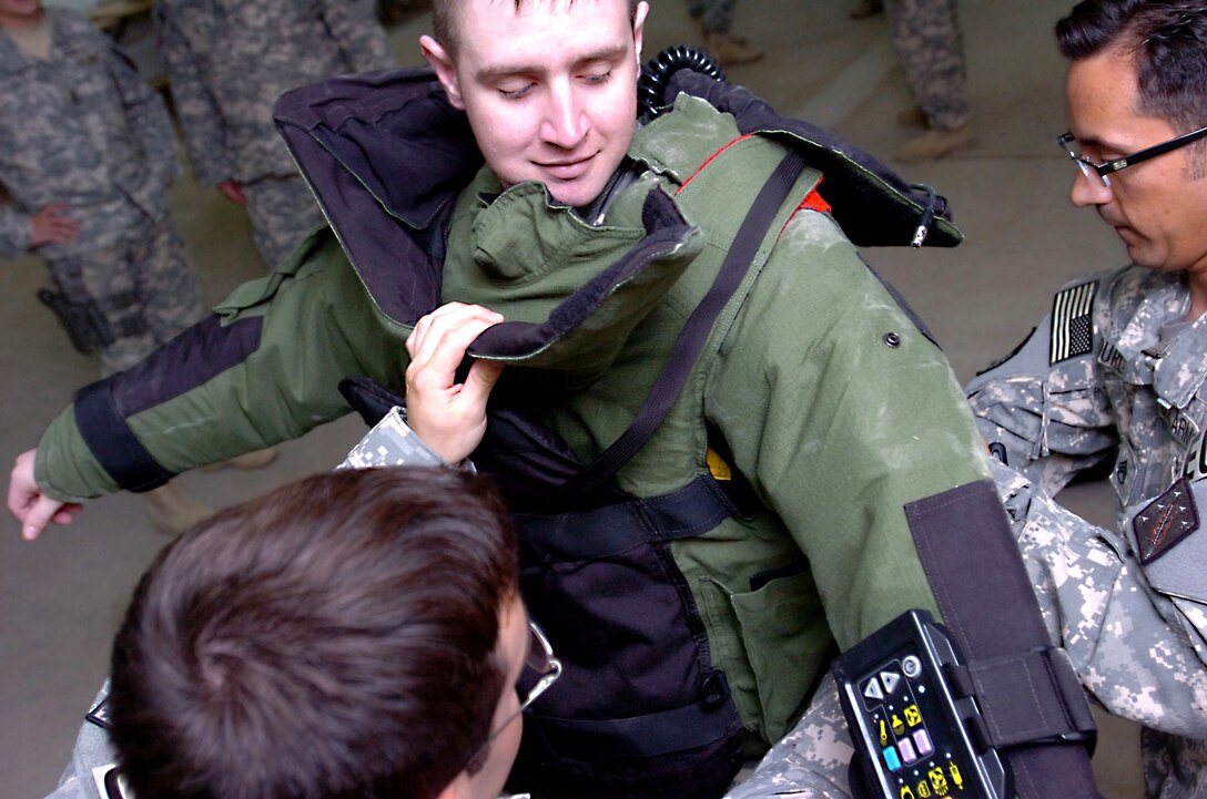 U.S. Army Sgt. Justin Pullen tries on an explosive ordanance device suit as he and 10 other wounded warriors travel to Basrah, Iraq, where they visited with troops as part of Operation Proper Exit VII, June 15, 2010. 