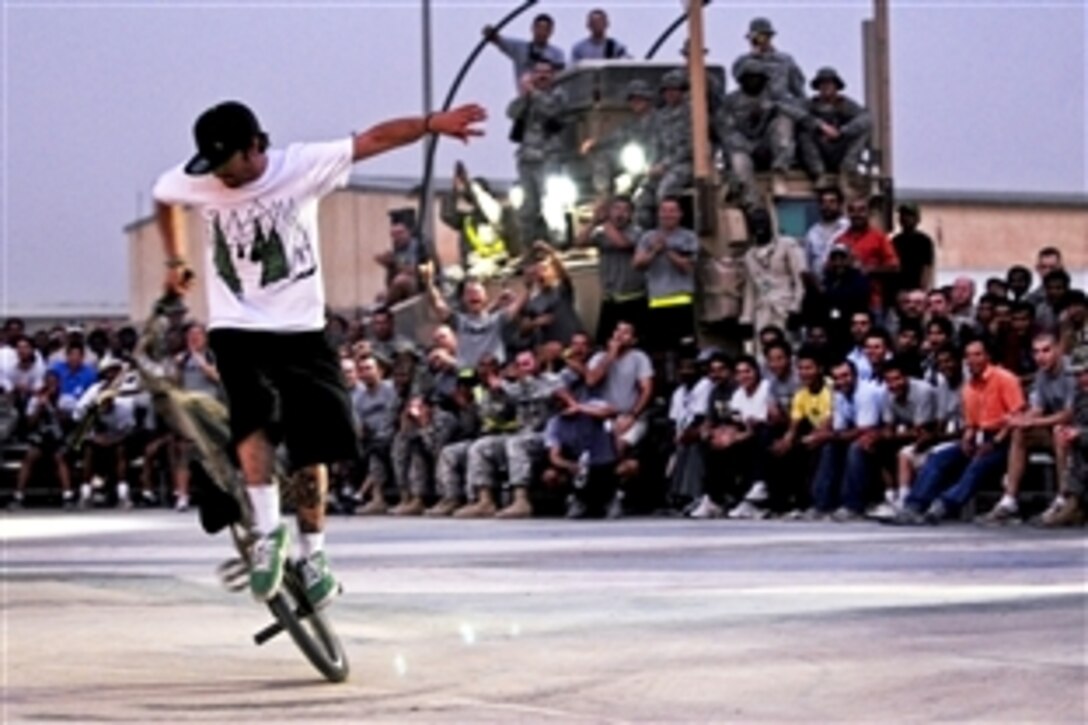 Zack ‘Catfish’ Yankush, a professional rider, performs street tricks during the Bikes Over Baghdad 2 event on Contingency Operating Station Falcon, Iraq, June 18, 2010. The soldiers are assigned to the 1st Advise and Assist Brigade.