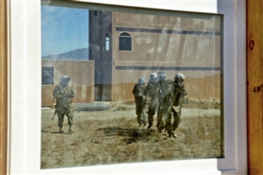 U.S. Marine Corps combat engineers approach a window during urban terrain training in Hawthorne, Nev., June 17, 2010. The Marines are assigned to the 473rd Marine Wing Support Squadron.
