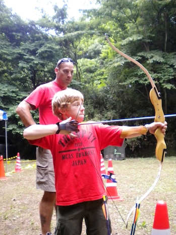 Tenderfoot David Rasmussen, 11, practices archery during Troop 77’s 2010 one-week summer camp in Camp Tama, Yokota, Japan.