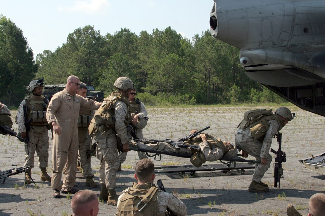 Marines with Company A, 2nd Assault Amphibian Battalion, practice loading a litter on to a CH-46E, during a Mission Rehearsal Exercise at Marine Corps Base Camp Lejeune, June 22. The three-day exercise, conducted by the special-purpose Marine Air-Ground Task Force was held to test the task force's unit readiness for the upcoming four-month deployment to Central and South American countries.