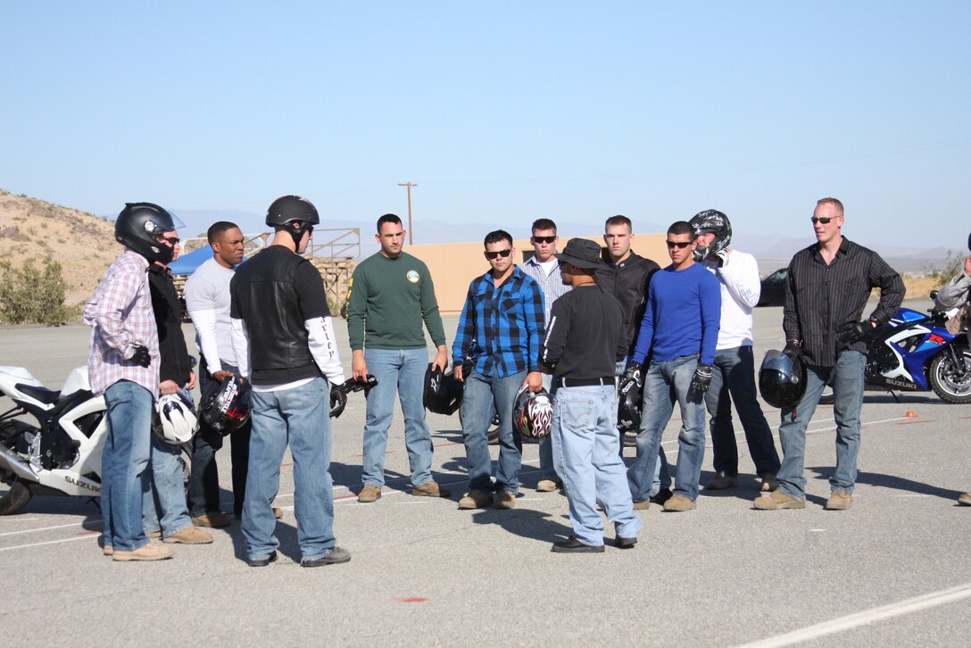 Frank Santiago [center], a Combat Center rider coach, instructs riders before an exercise during the Basic Riders Course next to the Combat Center Rifle Range June 22. The BRC is a three-day course which teaches riders elementary riding techniques and safety.