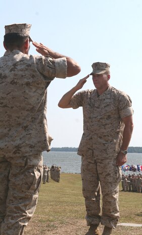 Col. John W. Simmons (right), the outgoing commanding officer of Combat Logistics Regiment 2, 2nd Marine Logistics Group, salutes Brig. Gen. Juan G. Ayala (left), the 2nd MLG commanding general, prior to receiving the Legion of Merit medal during a change of command ceremony aboard Camp Lejeune, N.C., June 22, 2010.  Simmons received the medal for outstanding performance while serving as CLR-2 commanding officer from June 2008 to June 2010.