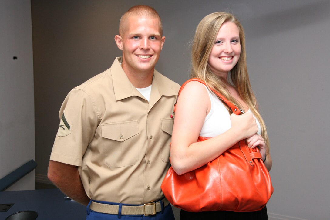 Lance Cpl. Daniel R. Hermann poses with Faison C. Powers of Hubert, N.C., holding her purse tightly. Powers had her purse snatched in late February, and Hermann tackled and detained the suspected purse thief until police arrived. Jacksonville, N.C., Mayor Sammy Phillips presented Hermann with a Civilian Commendation medal, June 22. Hermann is a motor transportation utilities mechanic assigned to Marine Wing Communications Squadron 28.