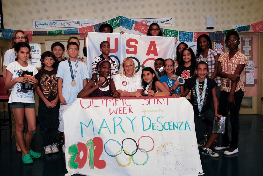 Youth from the Kishaba Youth Center pose with professional swimmer Mary Mohler at the center’s Olympic Day celebration, June 22. Mohler intends to compete in the 2012 Olympics in London.
