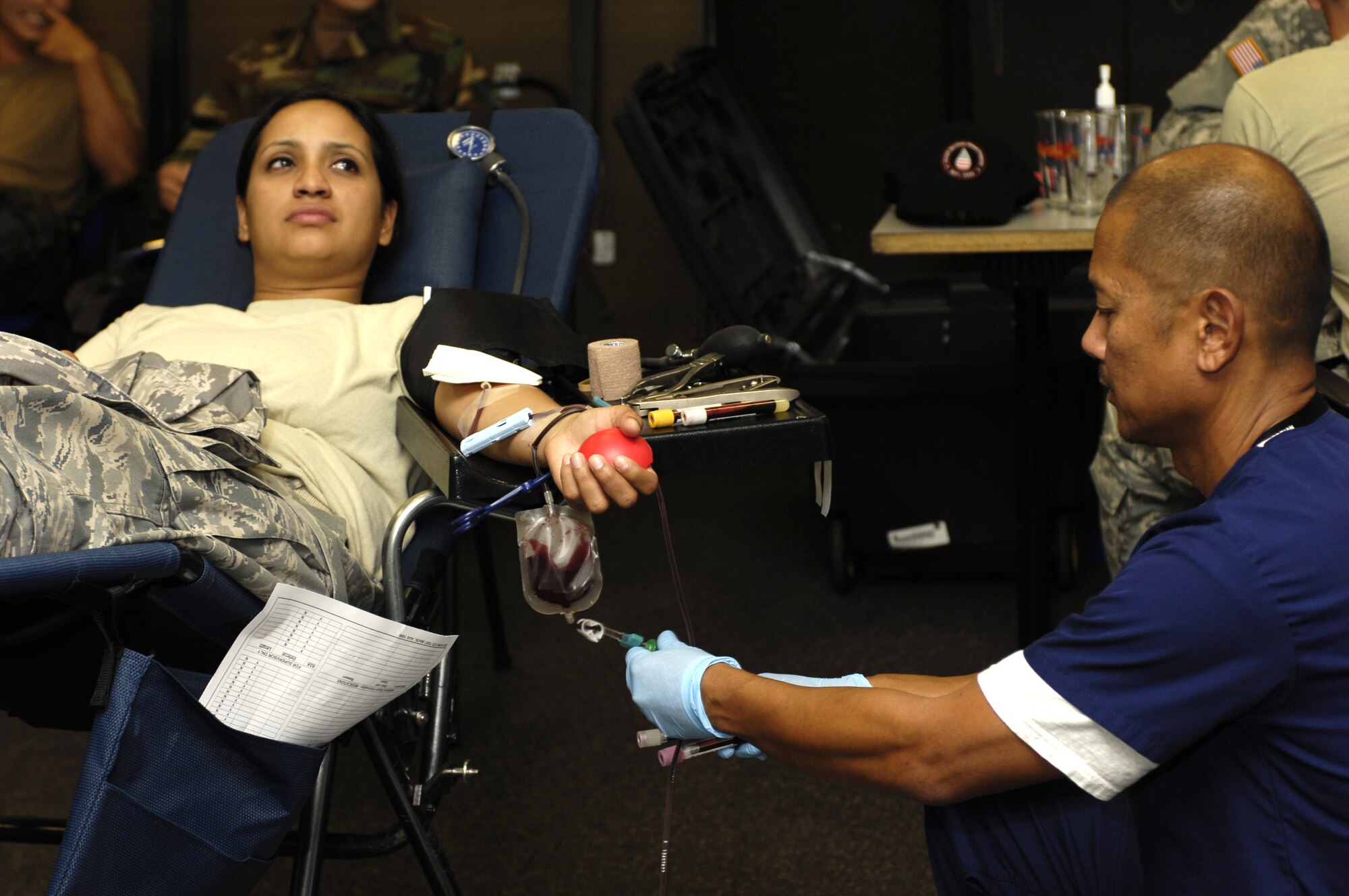 JOINT BASE PEARL HARBOR HICKAM, Hawaii - Technical Sergeant select Sarita Lomas, 735th Air Mobility Squadron controller, donates blood during a Blood Drive at the 15th Maintenance Group Consolidated Maintenance Complex on Joint Base Pearl Harbor-Hickam, Hawaii.  Sergeant Lomas is the Blood Drive monitor for the squadron.  The blood drive was hosted by the Tripler Army Medical Center, Hawaii on 17 June 2010. (Photo by David D. Underwood, Jr.)
