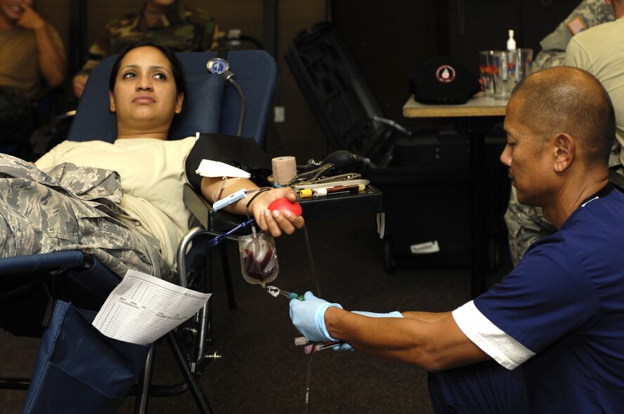 JOINT BASE PEARL HARBOR HICKAM, Hawaii - Technical Sergeant select Sarita Lomas, 735th Air Mobility Squadron controller, donates blood during a Blood Drive at the 15th Maintenance Group Consolidated Maintenance Complex on Joint Base Pearl Harbor-Hickam, Hawaii.  Sergeant Lomas is the Blood Drive monitor for the squadron.  The blood drive was hosted by the Tripler Army Medical Center, Hawaii on 17 June 2010. (Photo by David D. Underwood, Jr.)
