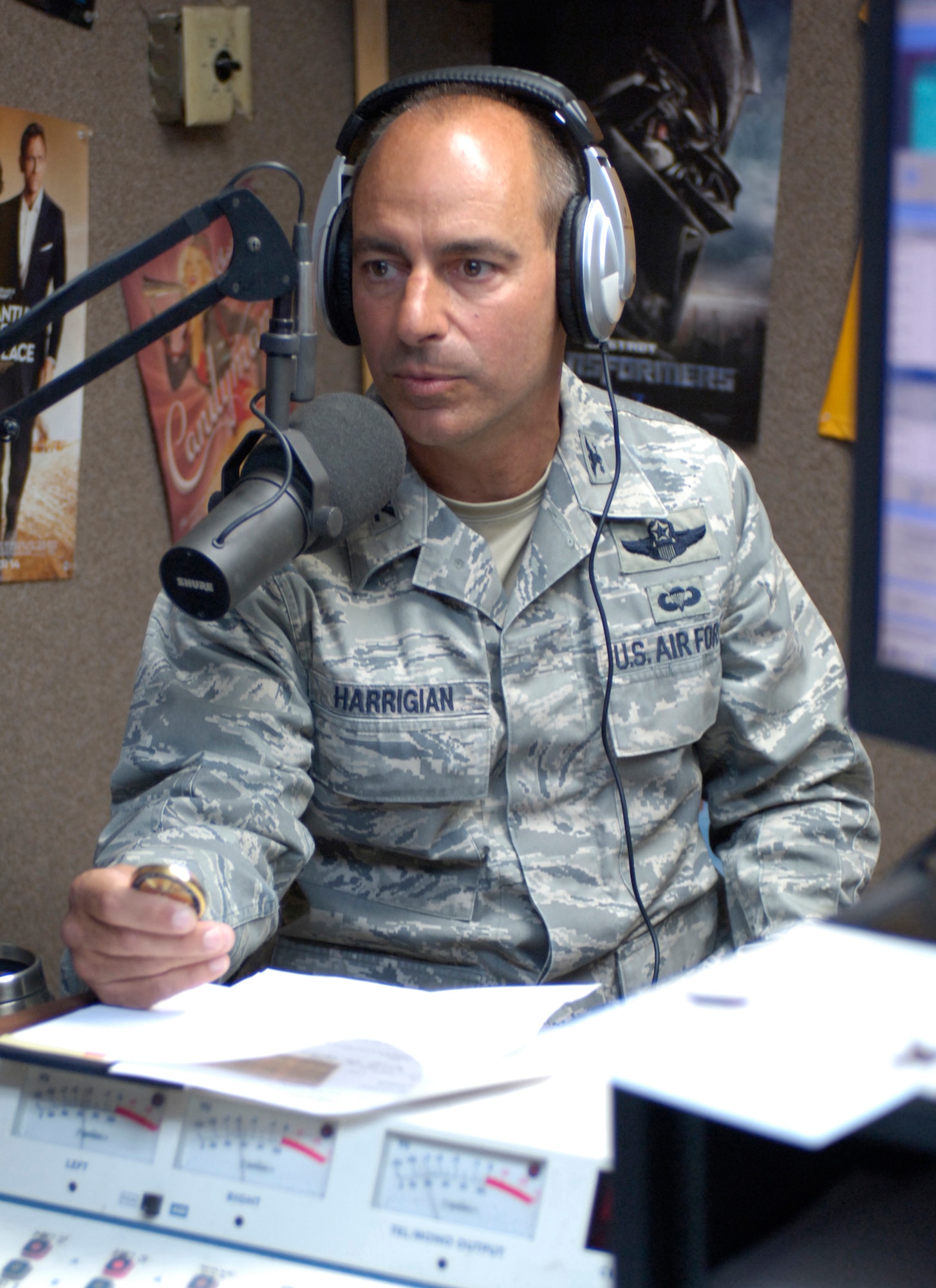 HOLLOMAN AIR FORCE BASE, N.M. -- Col. Jeff Harrigian, 49th Fighter Wing commander, "coins" radio personality Double J (James White) during his last "Commander's Corner" at 94 KYEE-FM June 11, 2010. This was the last show for both Colonel Harrigian and radio personality Double J. The presentation of a "coin" to someone who has done an outstanding job is a time-honored military tradition observed by all branches of the military. (U.S. Air Force photo by Mr. Arlan Ponder / Released)  