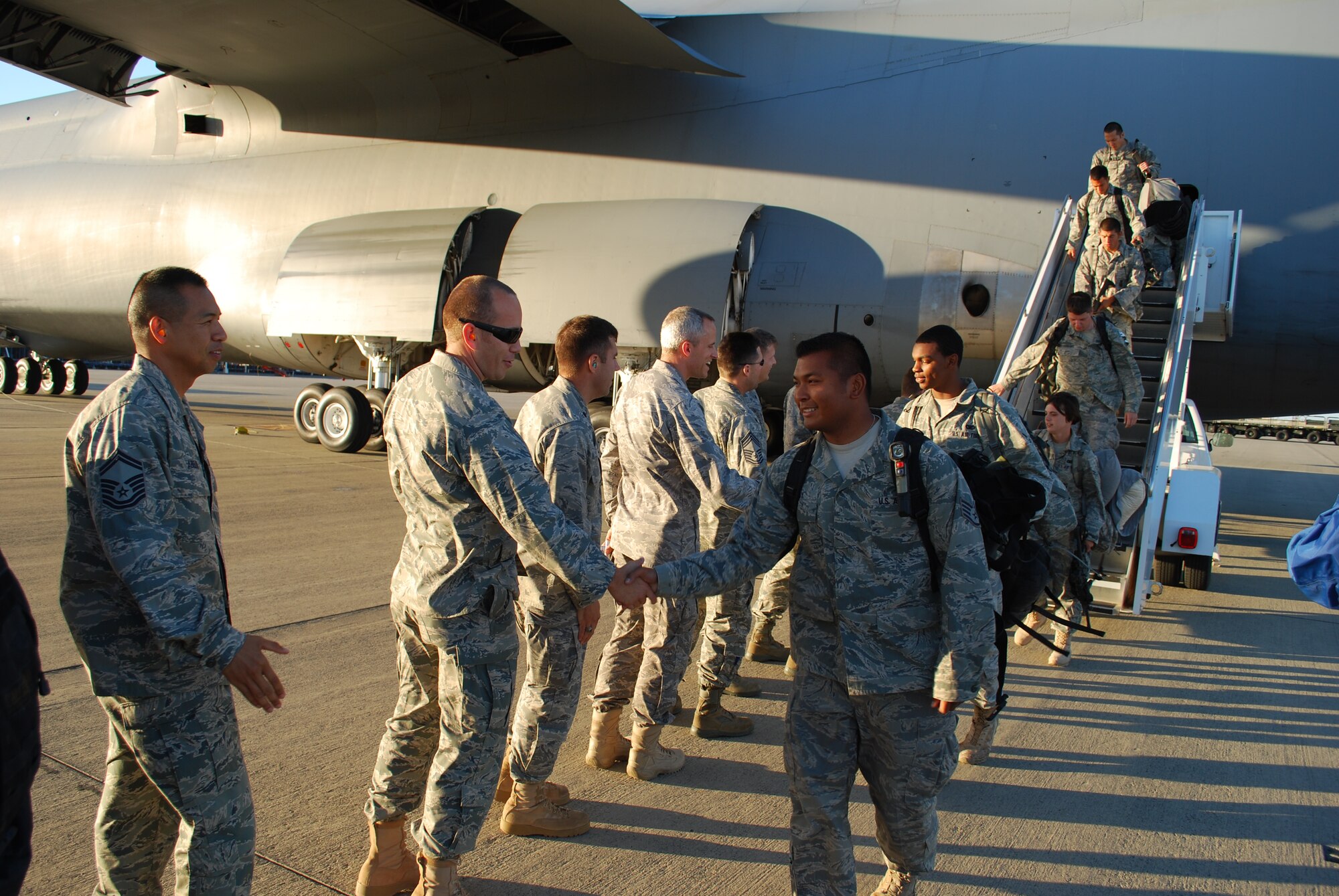Staff. Sgt. Tony Sengdy, 571st Global Mobility Squardon, shakes hands with Maj. Joseph Lippe, 573rd Global Support Squadron. Senior leadership of the 615th Contingency Response Wing welcomed home deployed Airmen as the return from Mazar-i-Sharif, Afghanistan.(U.S. Air Force photo/ Capt. Paradon Silpasornprasit)