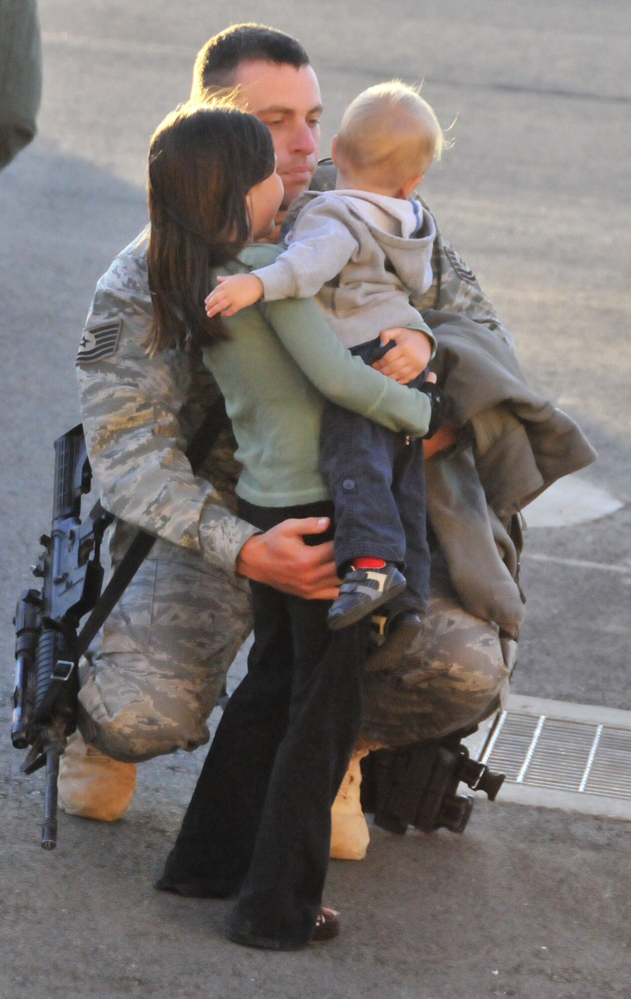 Tech. Sgt. Ryan Dornan, 570th Global Mobitily Readiness Squadron greets his children after being deployed to Afghanistan in support of Operation Enduring Freedom. The 615th Contingency Response Wing welcomed home its Airmen from deployment in Afghanistan. Hundreds of Team Travis leadership were on hand to greet the Airmen. In early February, more than 100 Airmen deployed to forward-operating base Mazar-i-Sharif in northern Afghanistan to establish airfield operations in support of Operation Enduring Freedom. (U.S. Air Force photo/ Capt. Paradon Silpasornprasit)