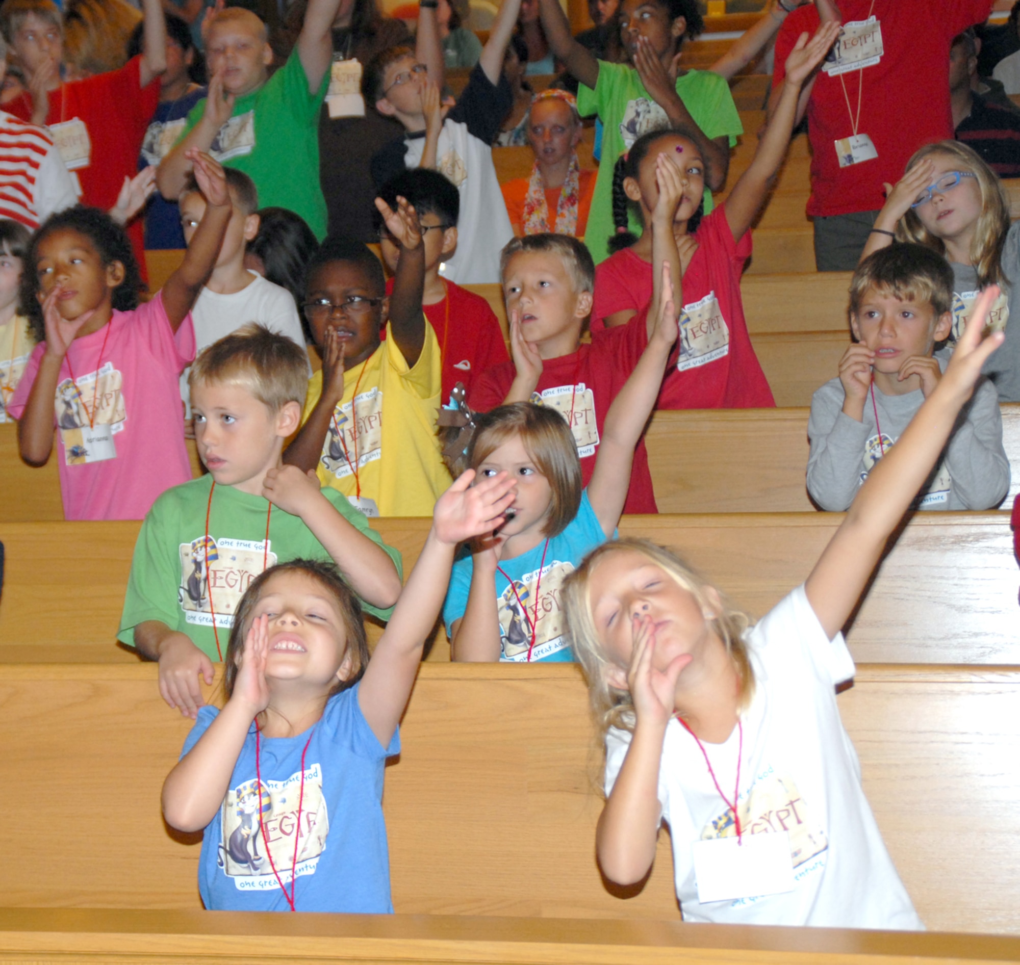 Students move and sing along with songs during the music portion of Vacation Bible School. More than 100 base children per day attended the base chapel's Vacation Bible School program. (U.S. Air Force photo by Mr. Arlo Taylor)