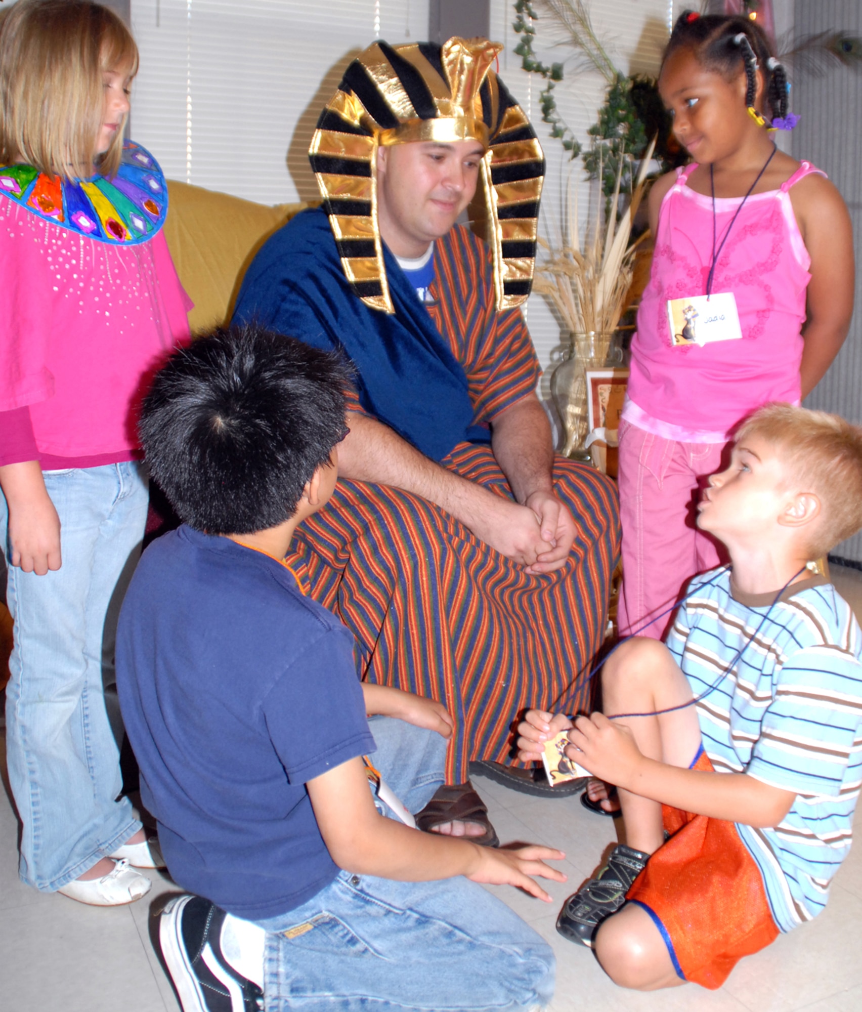 Joseph, portrayed by Tech. Sgt. James Rundall, 19th Aircraft Maintenance Squadron, talks with second-grade students June 16 after the story portion of "Egypt - Joseph's Journey from Prison to Palace" Vacation Bible School program at the base chapel. More than 100 children per day attended this year's program. (U.S. Air Force photo by Arlo Taylor)