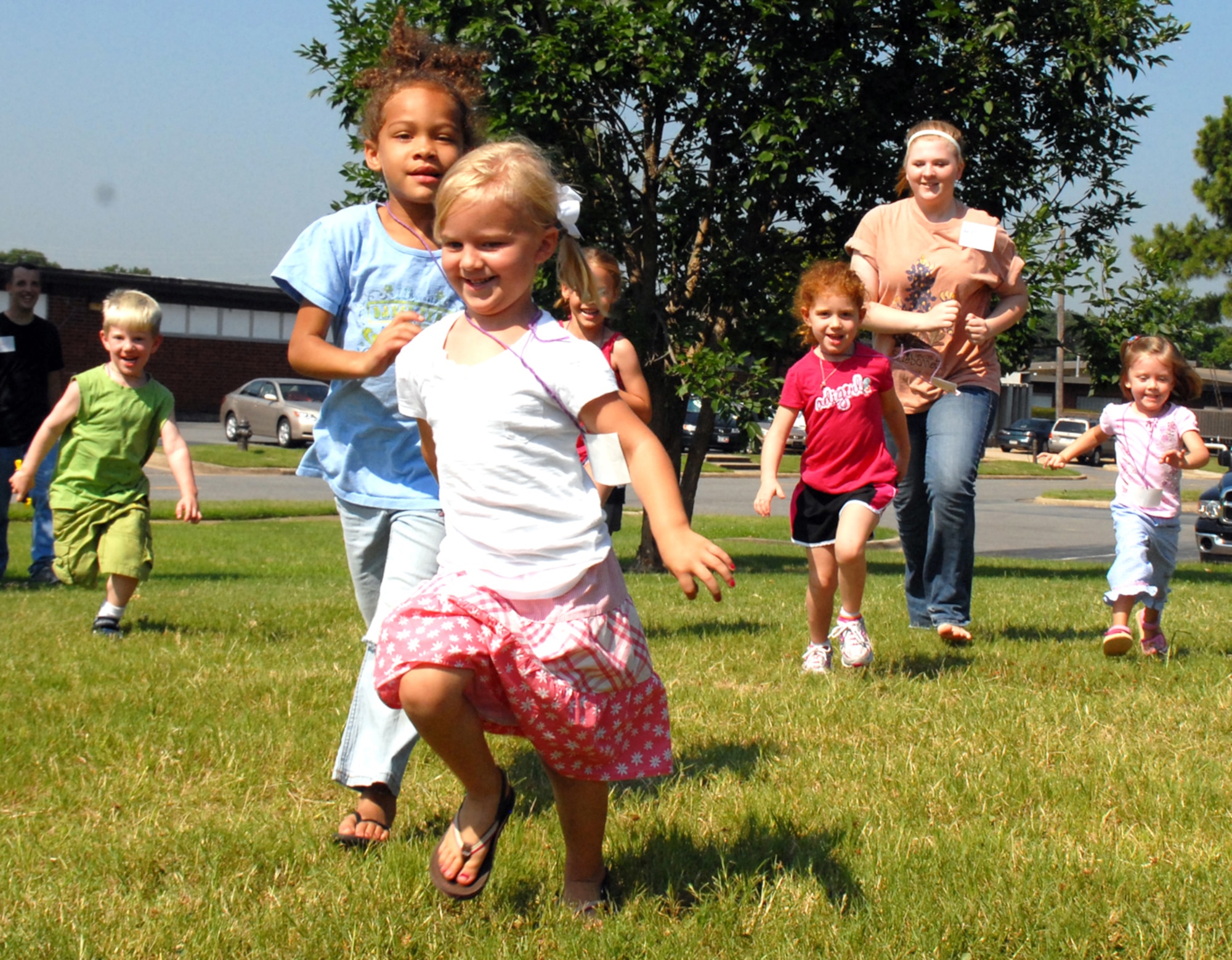 Chapel volunteer Rachel Scott plays tag with her Pre-K class during the Pyramid Playhouse portion of Vacation Bible School. Nearly 50 volunteers per day helped make the annual chapel summer program a success. (U.S. Air Force photo by Arlo Taylor)