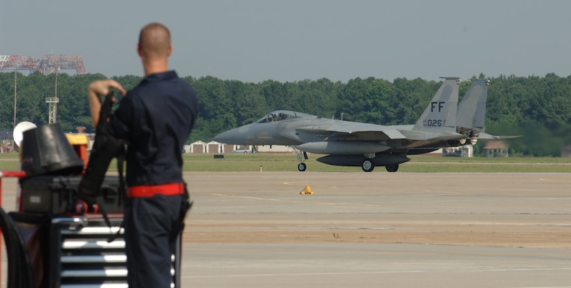 LANGLEY AIR FORCE BASE, Va. -- Senior Airman Grant Russell, 71st Aircraft Maintenance Unit F-15 crew chief, looks on as Capt. Brent Tittle, 71st Fighter Squadron pilot, taxis F-15 Eagle tail number 83-026 along the flight line June 21. Tittle delivered the aircraft to Nellis Air Force Base, Nev., one of the first two Eagles transferred to other units due the impending inactivation of the 71 FS. (U.S. Air Force photo/Airman 1st Class Jason J. Brown)