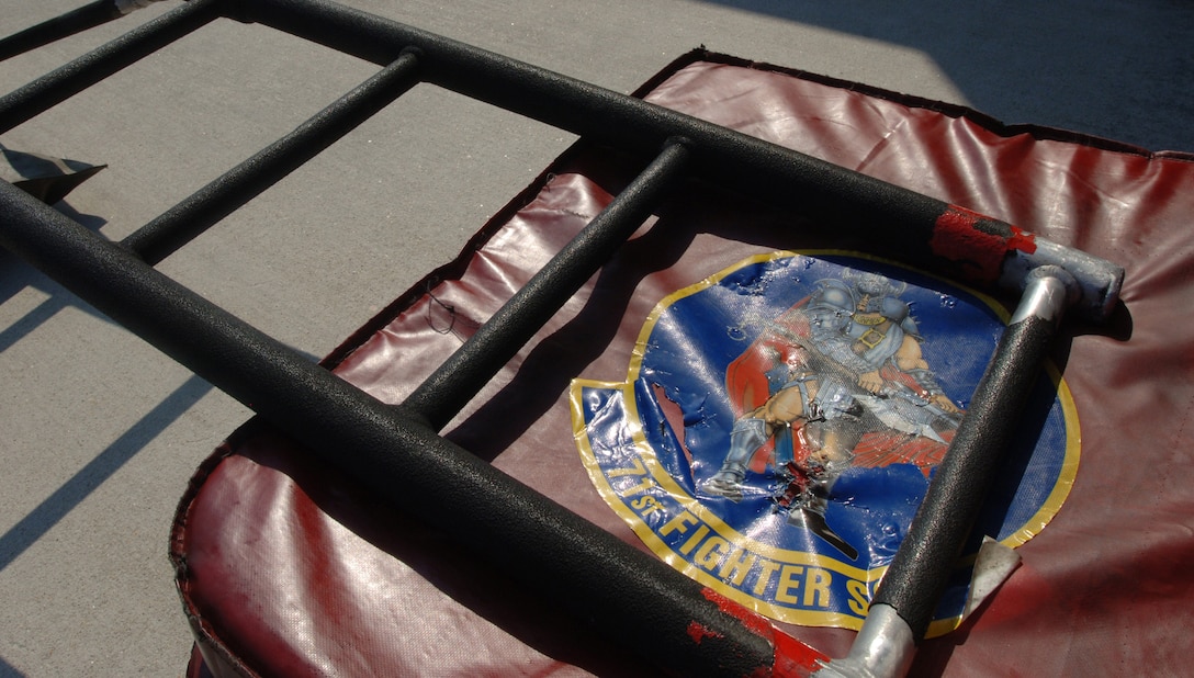 LANGLEY AIR FORCE BASE, Va. -- An F-15 Eagle intake cover, featuring the squadron’s “Ironman” unit insignia, rests beneath a cockpit access ladder on the flight line June 21. The squadron transferred the first two Eagles to other units due the impending inactivation of the 71 FS. (U.S. Air Force photo/Airman 1st Class Jason J. Brown)