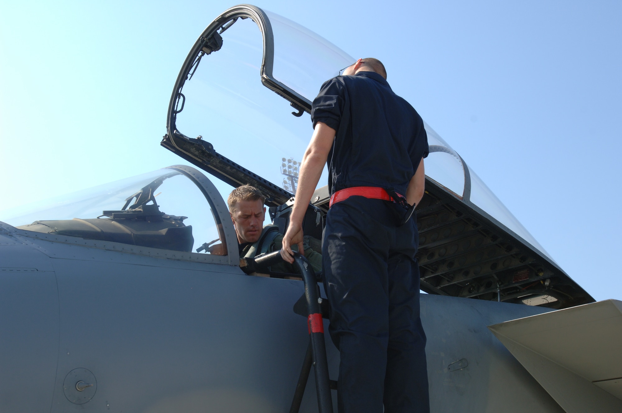 LANGLEY AIR FORCE BASE, Va. -- Capt. Brent Tittle (in cockpit), 71st Fighter Squadron pilot, and Senior Airman Grant Russell, 71st Aircraft Maintenance Unit F-15 crew chief, perform a pre-flight inspection on F-15 Eagle tail number 83-026 June 21. Tittle delivered the aircraft to Nellis Air Force Base, Nev., one of the first two Eagles transferred to other units due the impending inactivation of the 71 FS. (U.S. Air Force photo/Airman 1st Class Jason J. Brown)