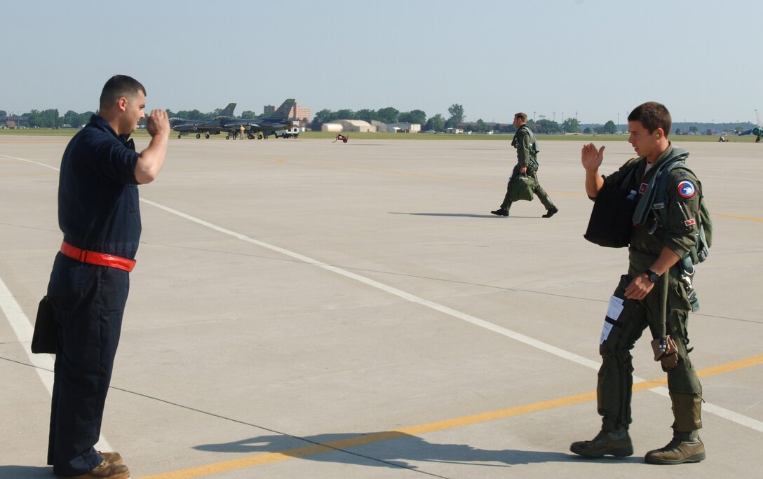LANGLEY AIR FORCE BASE, Va. -- Senior Airman Brandon Straub, 71st Aircraft Maintenance Unit F-15 crew chief, salutes Capt. Jeffrey Vanderbilt, 71st Fighter Squadron pilot, on the flight line June 21. Vanderbilt delivered F-15 Eagle tail number 84-024 to Nellis Air Force Base, Nev., one of the first two Eagles transferred to other units due the impending inactivation of the 71 FS. (U.S. Air Force photo/Airman 1st Class Jason J. Brown)