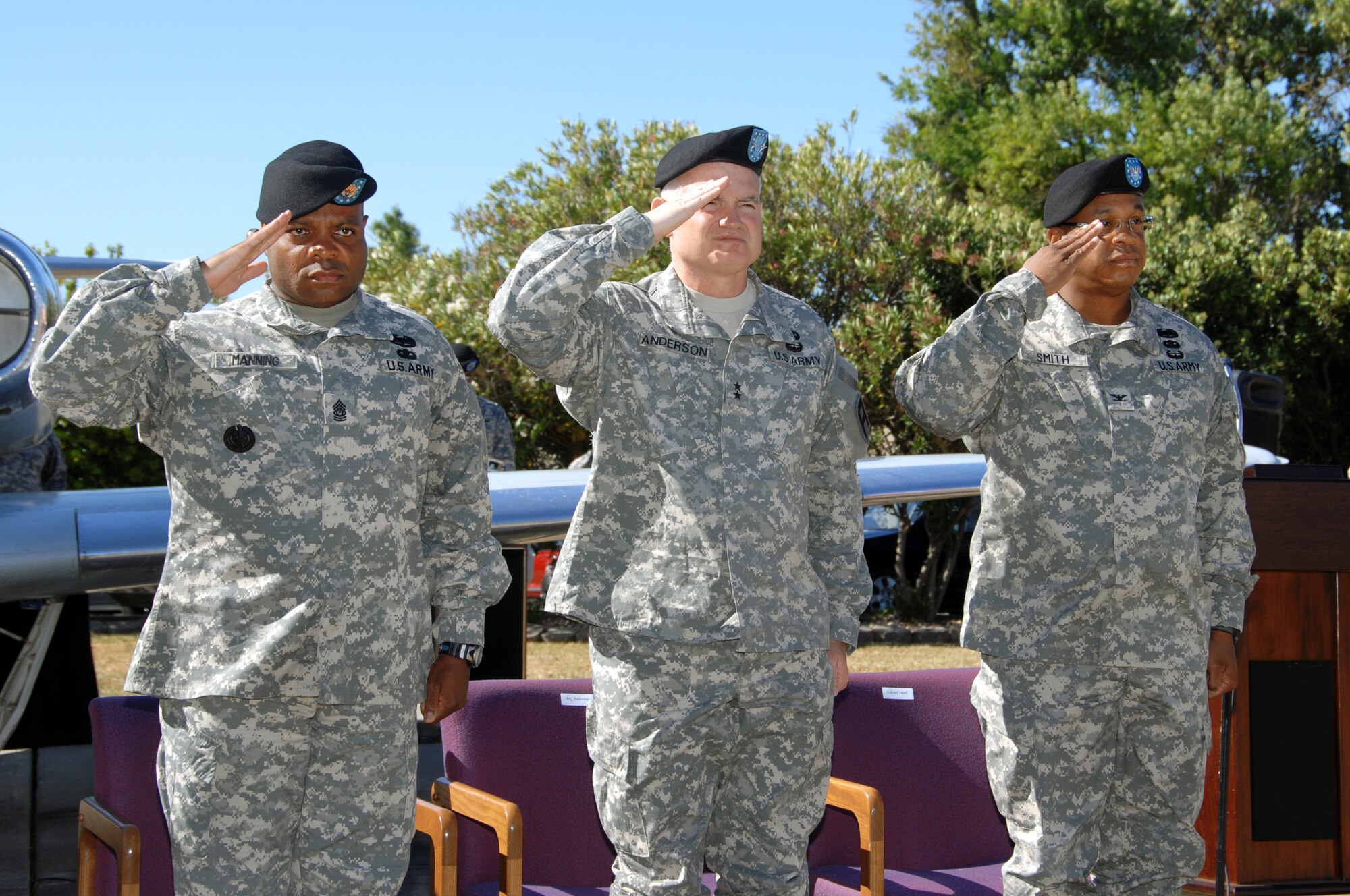 Left to right, 1st Army Division West Commander, Maj. Gen. Charles Anderson, 402nd Field Artillery Brigade Commander Col. Tracy Smith and Command Sergeant Major George Manning salute the American Flag during the Field Artillery Brigade Casing Ceremony at Travis Air Force Base, Calif. June 11.  (U.S. Air Force photo by Civ/Nan Wylie)

