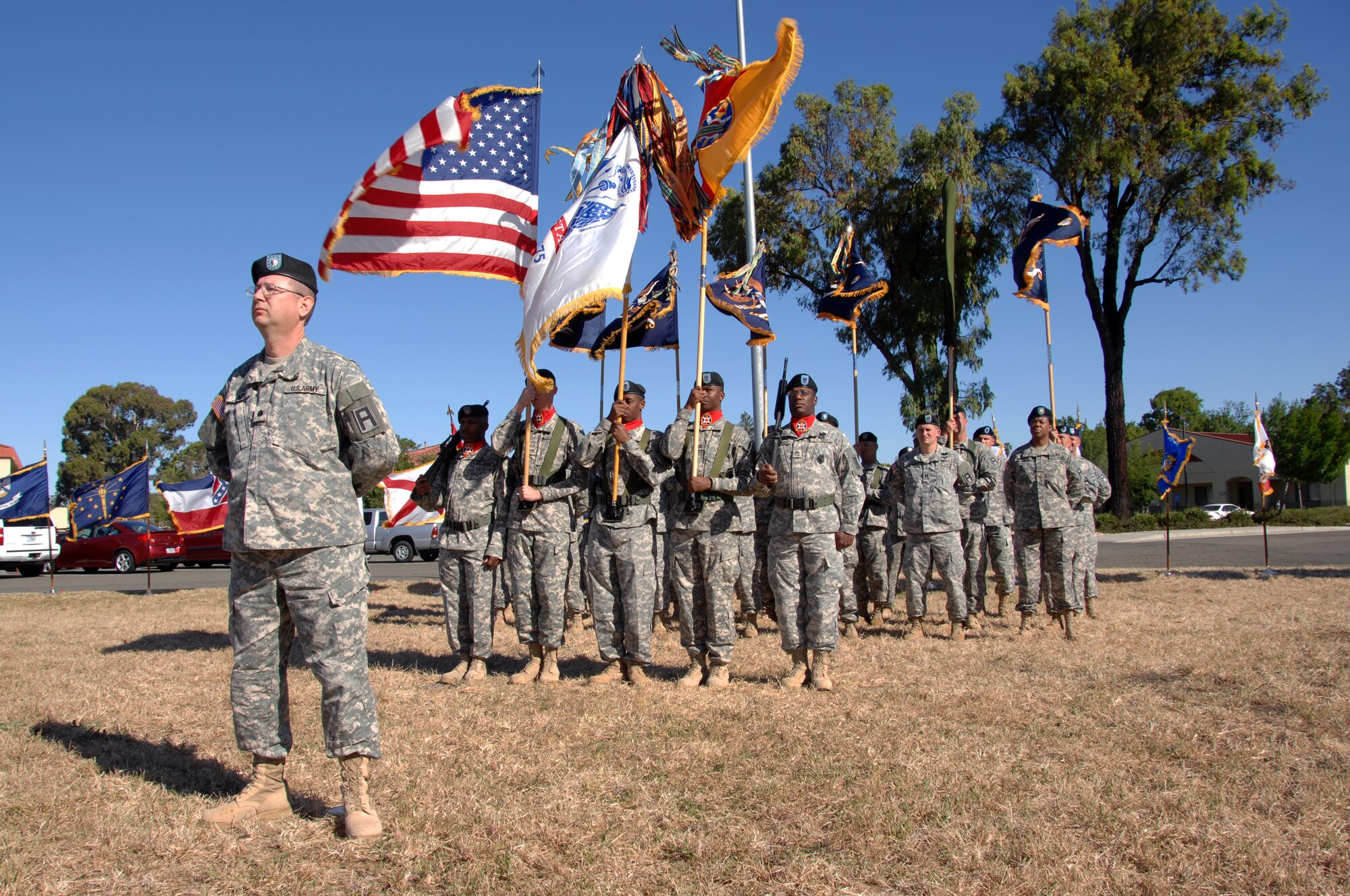 Commander of Troops, Lt. Col. Thomas Semple, left, stands at parade rest prior to the 402nd Field Artillery Brigade Casing Ceremony at Travis Air Force Base, Calif. June 11.  (U.S. Air Force photo by Civ/Nan Wylie)