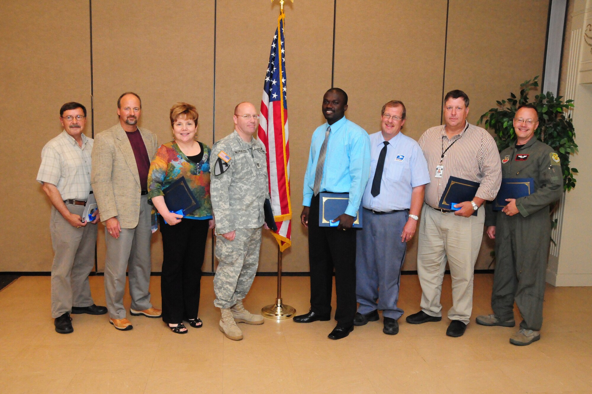 June 22, 2010, Federal employee award recipients from left to right, Dan Pihlaja, U.S. Postal Service (Safety-Security Award), Gary Keller, IRS (Law Enforcement Award), Laurie Whitehead, VA Medical Center (Professional-Scientific-Technical Award), Capt. Lucas Morales, Fargo Military Entrance Processing Station (Team Award), Constant L. Maninga, Fargo Military Entrance Processing Station (Administrative Operational Support Award), Rod Brasel, U.S. Post Office (Managerial Supervisor Award), Jim Van Hoecke, U.S. Post Office (Trade-Crafts Award), Master Sgt. Dave Somdahl, N.D. Air National Guard (standing in for Staff Sgt. Jeffrey Jacobson, Heroism - Valor Award and Civil Servant of the Year winner) at the Federal Executive Association Awards Luncheon, Holiday Inn Fargo, N.D.