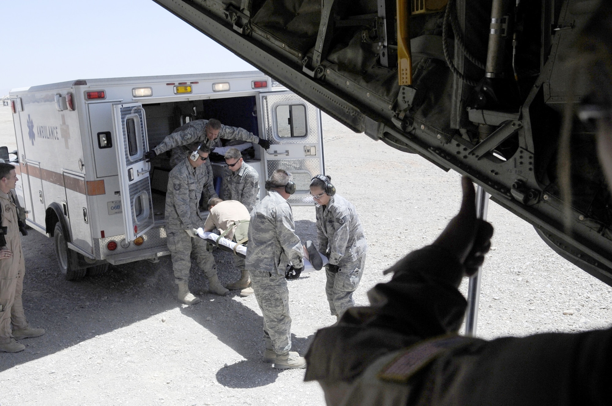 Members of the 451st Expeditionary Aeromedical Evacuation Squadron load a litter patient onto a C-130J Hercules June 9 at Camp Bastion, Afghanistan, during a bandage mission. Bandage missions require the team to travel to different bases throughout Afghanistan, pick up patients and transport them to receive a higher level of care. (U.S. Air Force photo/Senior Airman Nancy Hooks)