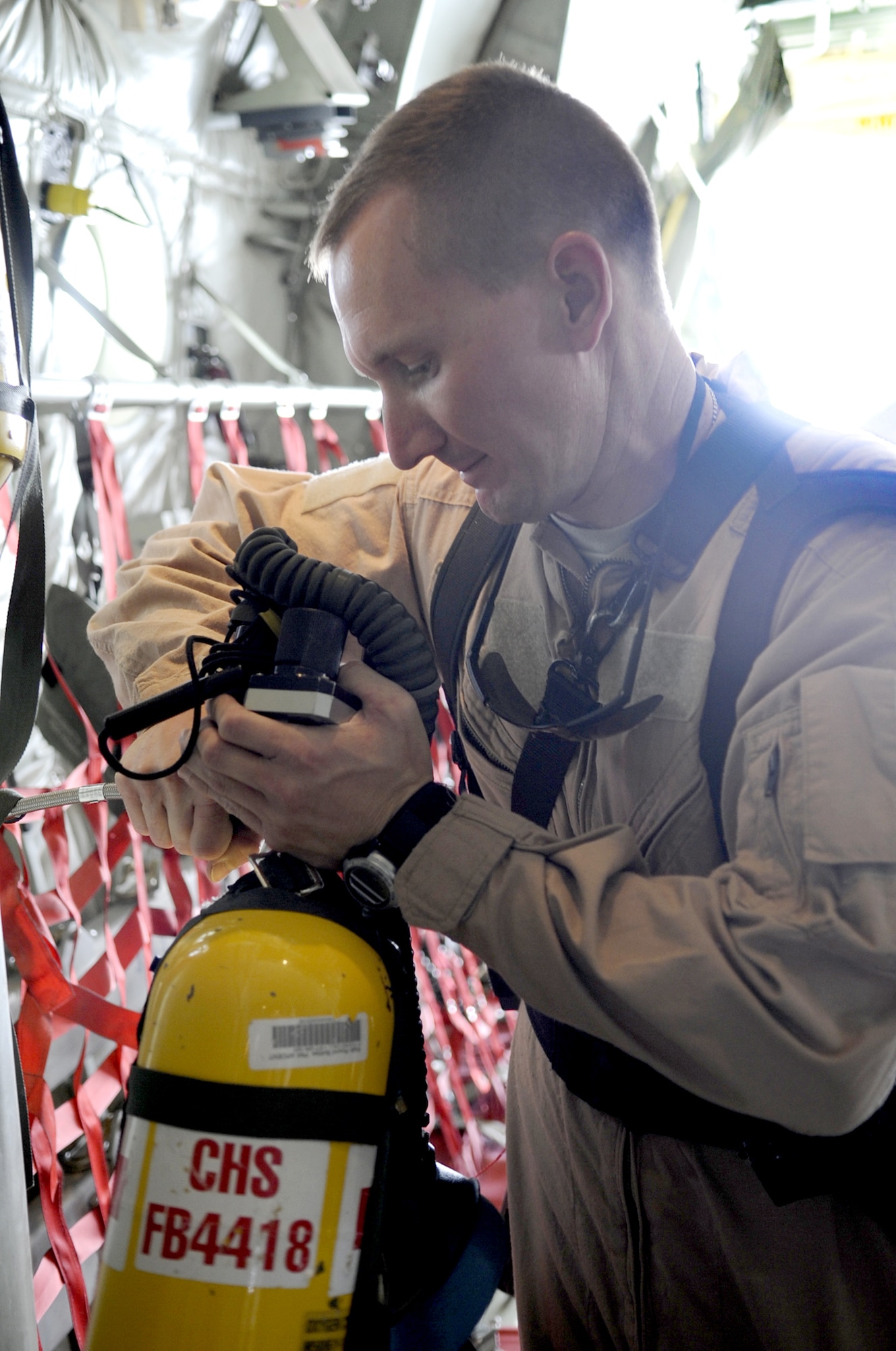 Maj. David Bailey refills an emergency oxygen tank prior to take off on an aeromedical evacuation mission June 9 at Kandahar Airfield, Afghanistan. Major Bailey is assigned to the 451st Expeditionary Aeromedical Evacuation Squadron. (U.S. Air Force photo/Senior Airman Nancy Hooks)