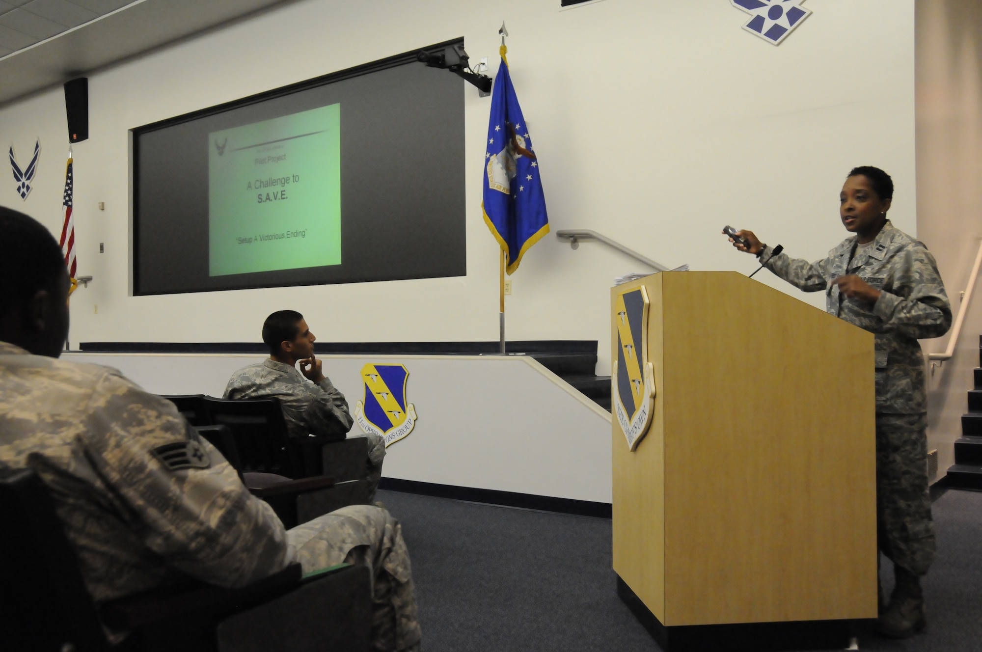Chaplain (Capt.) Ruth Segres, 11th Wing chaplain, debuts the first SAVE program briefing June 22 at the Stewart Theater. The program is aimed at junior enlisted Airmen and company grade officers to encourage them to take their financial futures into their own hands and begin putting money away at the genesis of their careers, and make saving an ingrained part of their lifestyle. (U.S. Air Force photo by Airman 1st Class Susan Moreno)