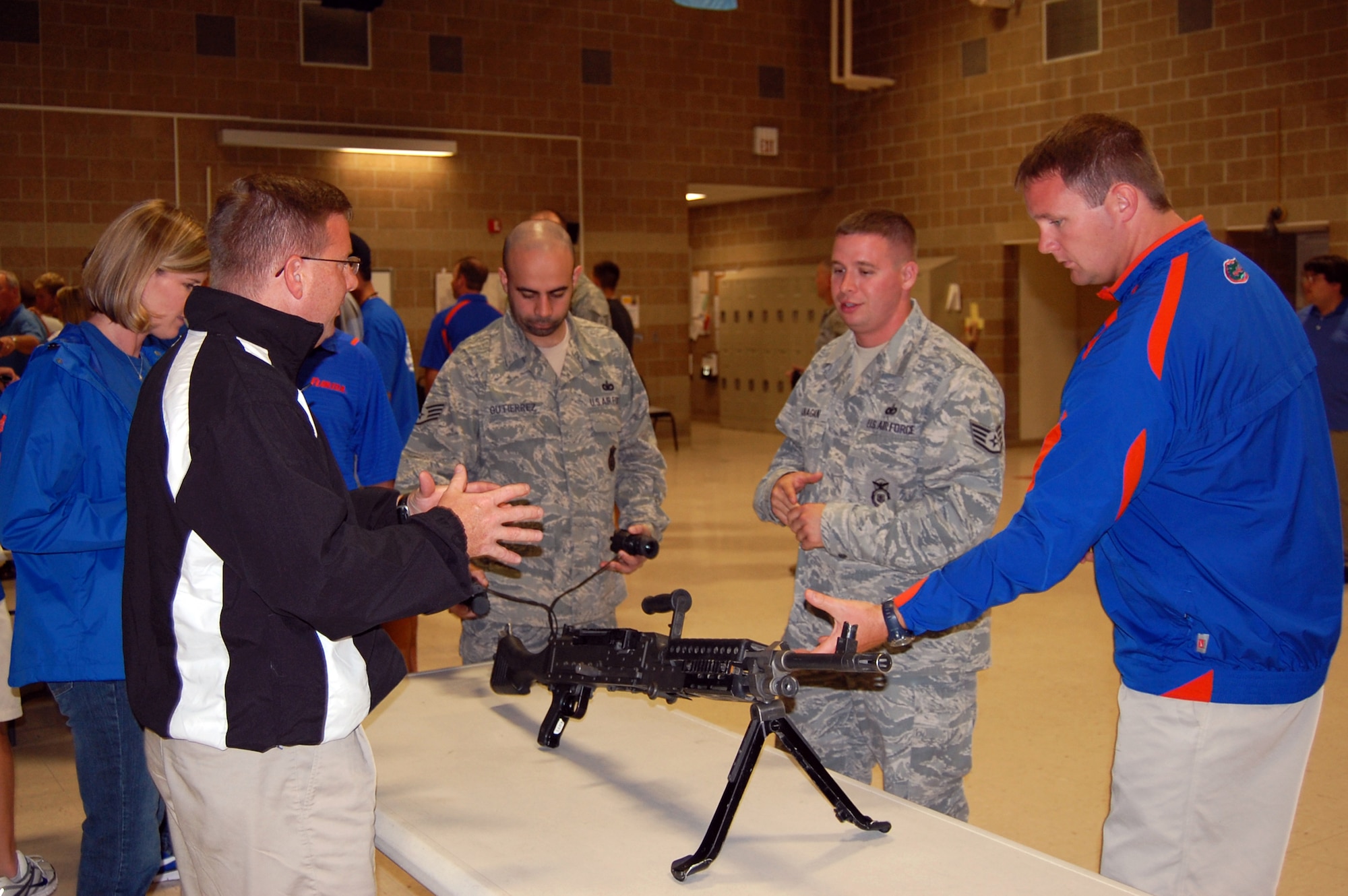 OFFUTT AIR FORCE BASE, NE - 55th Security Forces Squdron members Staff Sergeants Dale Gutierrez and Brian Flanagan showcase weaponry to the University of Florida Gators baseball team during a visit to Offutt on June 20. As the official sponsor of the Gators for the 2010 College World Series, 55th Wing members treated the team to a base tour, a weapons demonstration and barbecue dinner at the Community Center.  U.S. Air Force photo by 1st Lt. Kenneth Scholz 