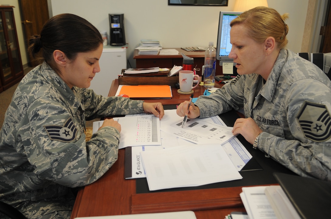 Staff Sgt. Reina Blake, 316th Wing Judge Advocate noncommissioned officer in charge of military justice, and Master Sgt. Dawn Vetter, 316th WG JA superintendent Joint Base Andrews Legal Office, review statistics for military justice processing at Joint Base Andrews, Md. June 22, 2010.  JA office provides legal services that support the operation, people, infrastructure, and security of the installation. (U.S. Air Force photo by Senior Airman Melissa V. Brownstein 