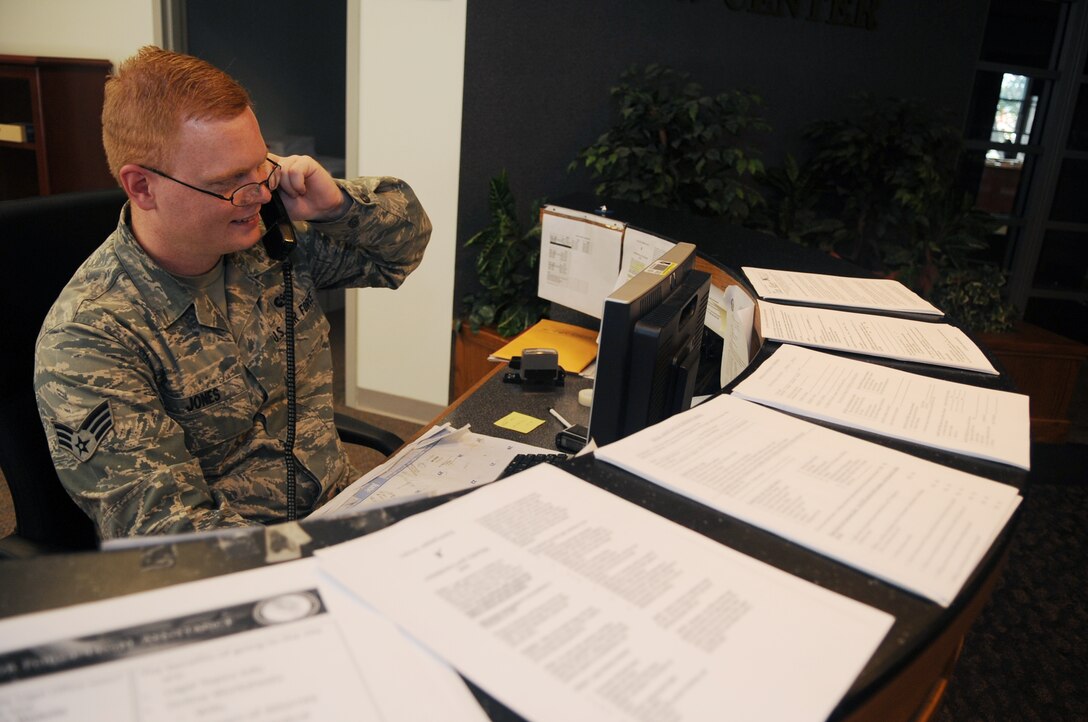 Senior Airman Samuel Jones, 316th Wing Judge Advocate military justice paralegal, assists a customer on the phone at Joint Base Andrews, Md. June 22, 2010.  The JA office provides legal services that support the operation, people, infrastructure, and security of the installation. (U.S. Air Force photo by Senior Airman Melissa V. Brownstein) 