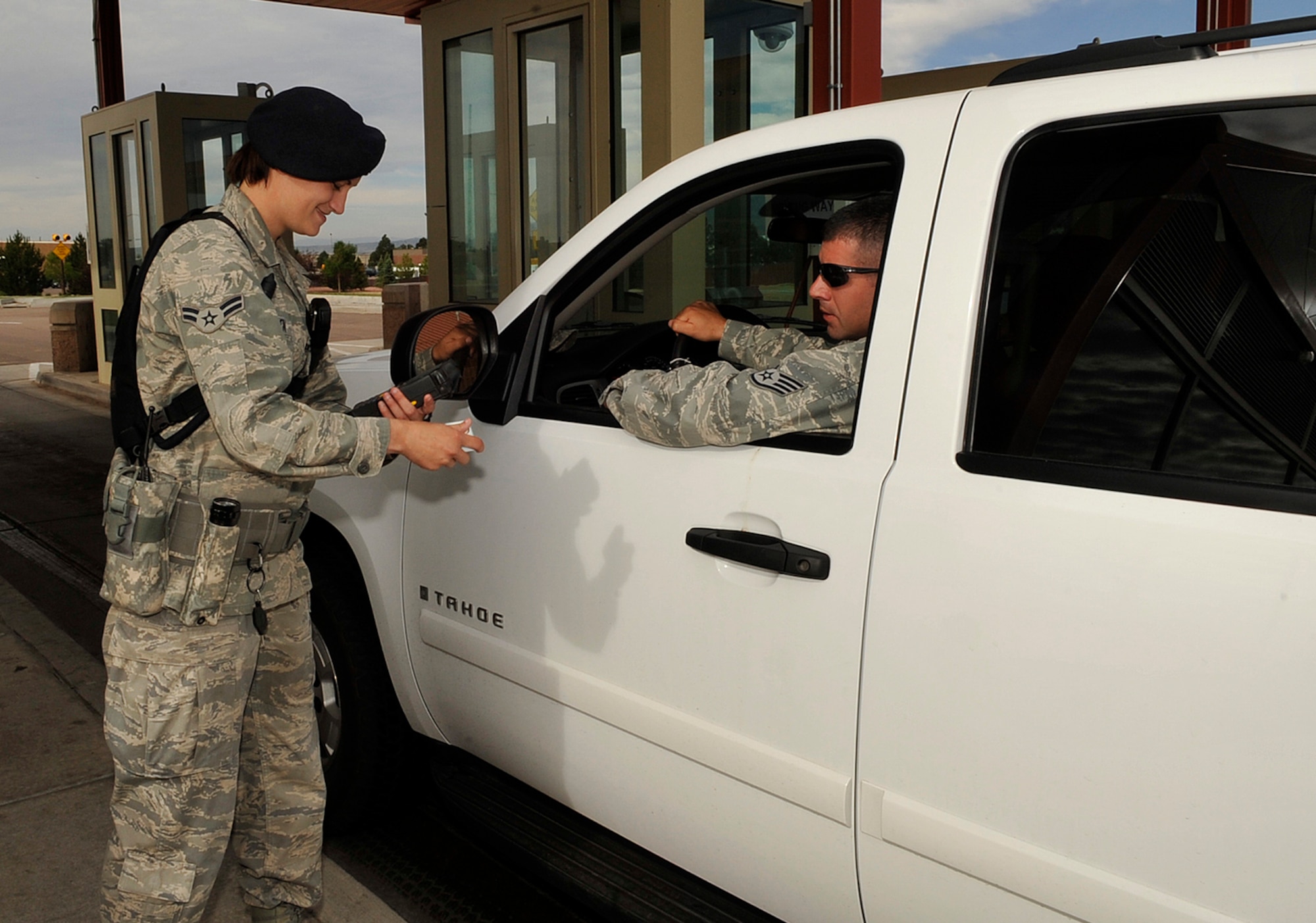 Airman 1st Class Tara Warren, 21st Security Forces Squadron, checks an ID June 22 using the DBIDS system. The 21st SFS has been conducting random security checks at all of Peterson’s entry gates to ensure compliance with the new Defense Biometric Identification System initiated by the Department of Defense and Homeland Security. The random checks will lead up to 100 percent DBIDS enforcement. (U.S. Air Force photo/Rob Bussard)