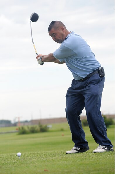 Lt. Col. Korwin Miike, 319th Aircraft Maintenance Squadron, takes a swing at his golf ball while teeing off June 21 during the Military Affairs Committee Golf Tournament at Grand Forks Air Force Base, N.D. The MAC Golf Tournament is an annual golf scramble consisting of two tournaments, one on Grand Forks AFB and one in the city of Grand Forks. Each four-man team is made up of both base personnel and members of the Grand Forks community. The event has been taking place since the 1980’s and continues to be a unique way for base and community members to interact. (U.S. Air Force photo by Tech. Sgt. Johnny Saldivar)
